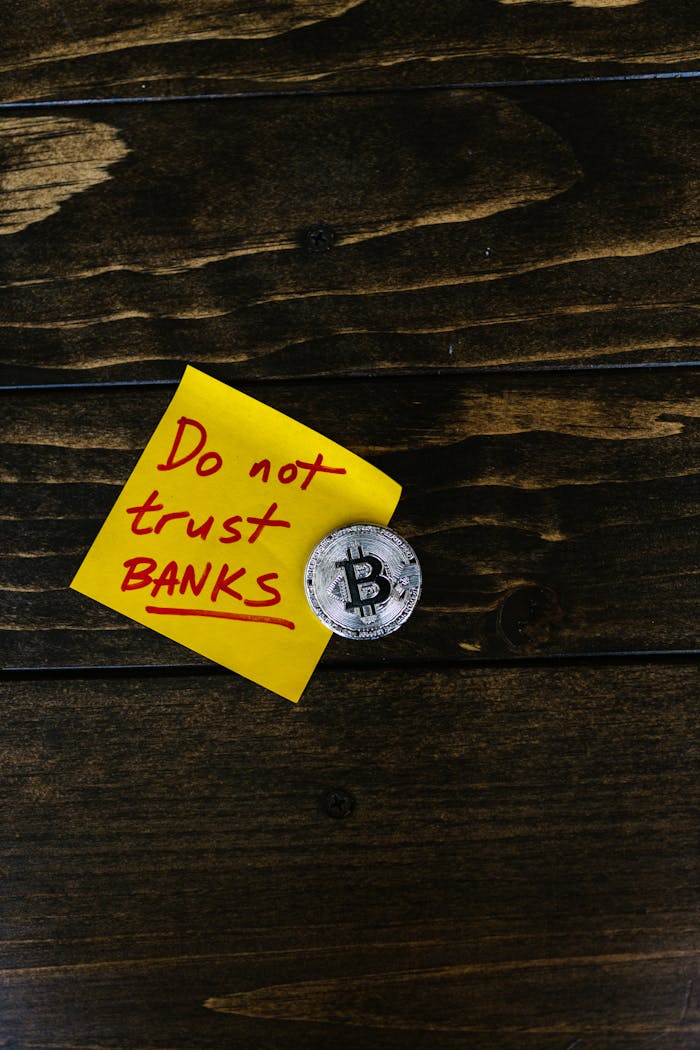 A conceptual image of a bitcoin coin next to a note that says 'Do not trust banks'.